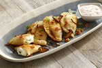 Loaded Potato Pierogi with Mushroom Bacon and Chili Crema